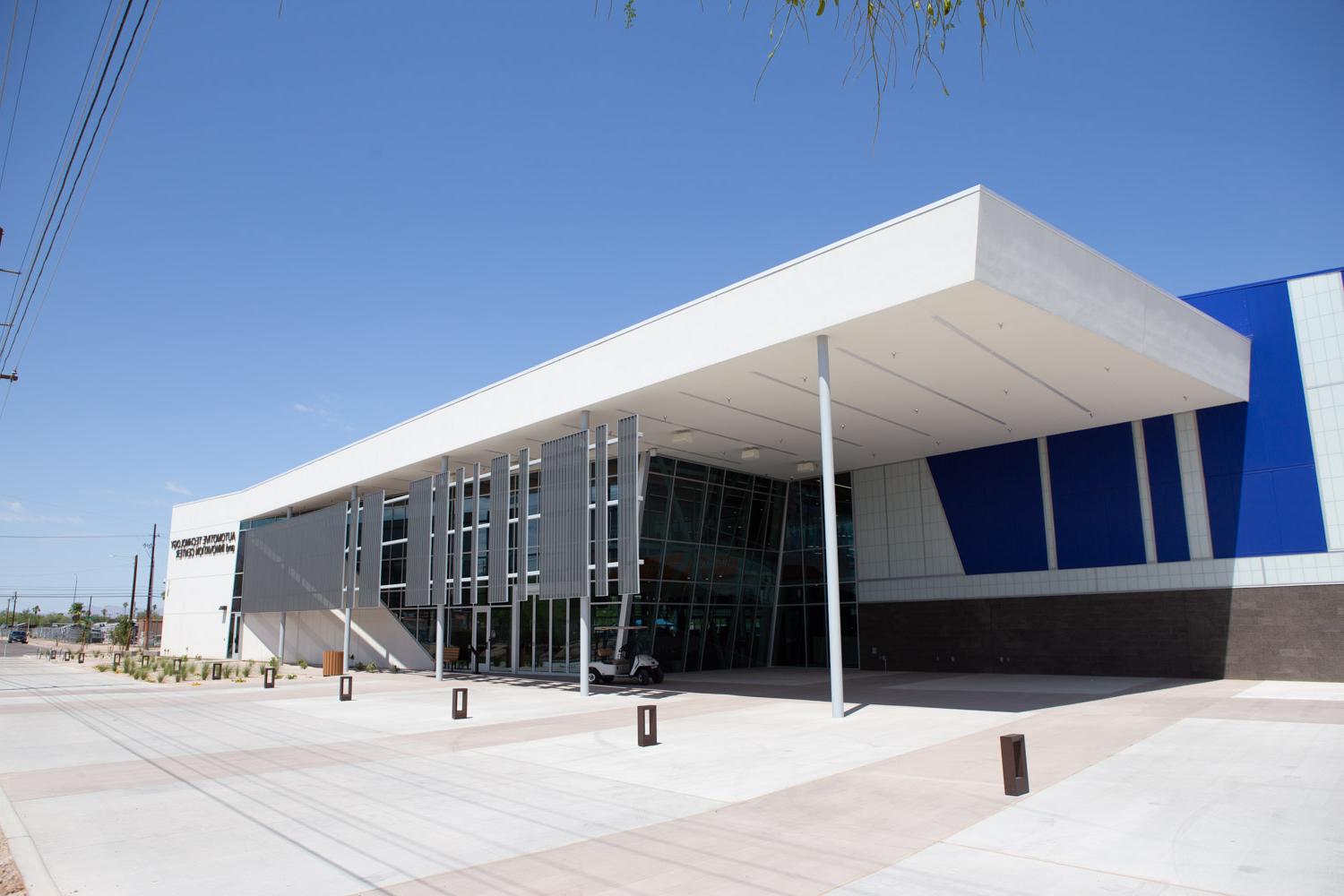 Automotive tech center, white building with desert landscaping.