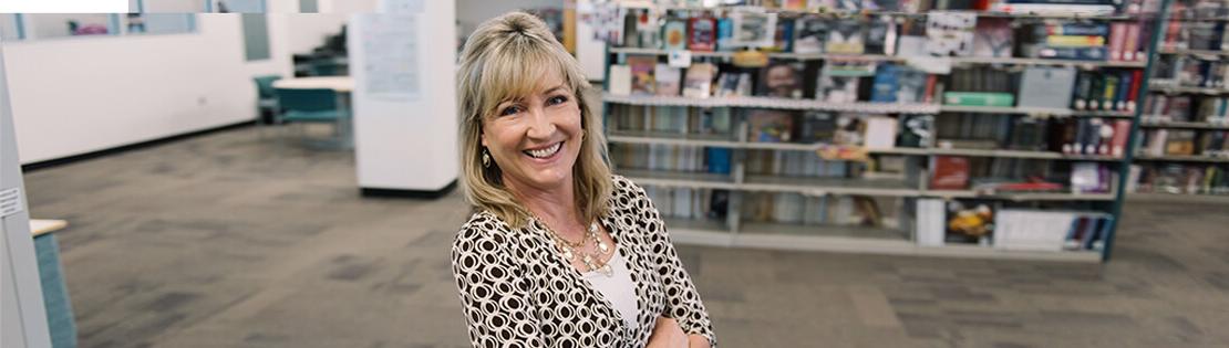 A senior student poses in a Pima Library